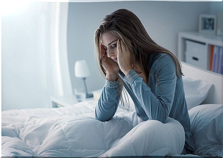 Woman in bed with insomnia from stress 