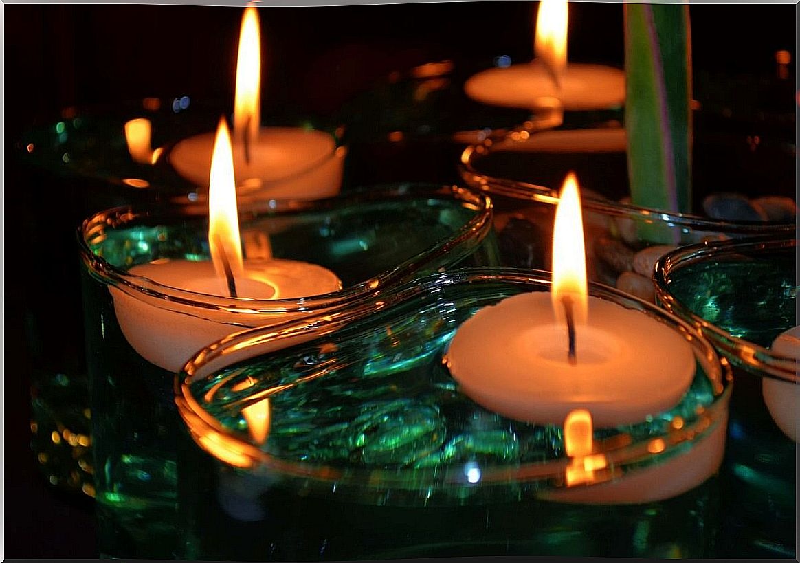 Floating candles in water.