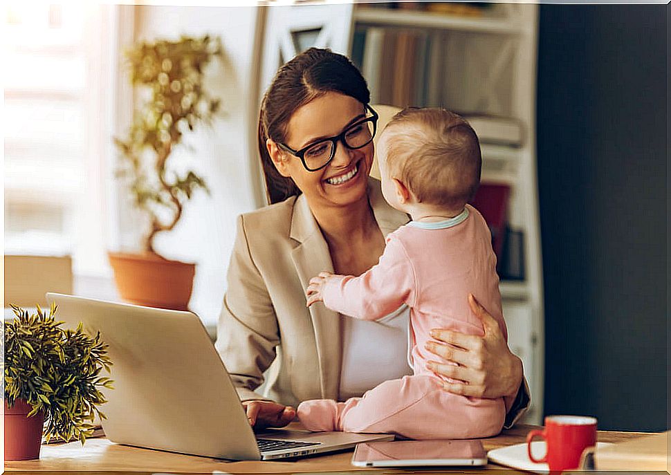 Woman in the office with her little daughter