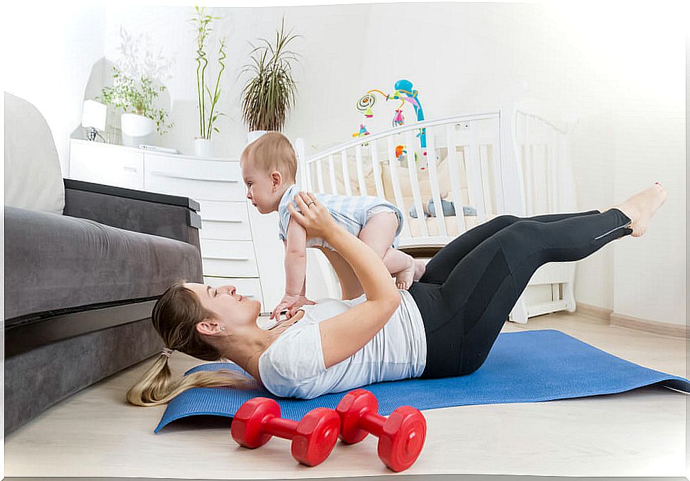 35 year old woman with her baby exercising