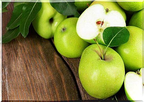 Green apples on wood