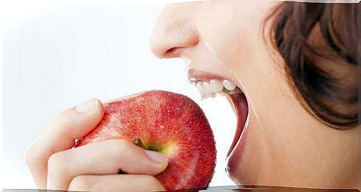 Woman about to bite into apple