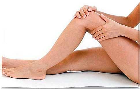 Woman massaging her legs